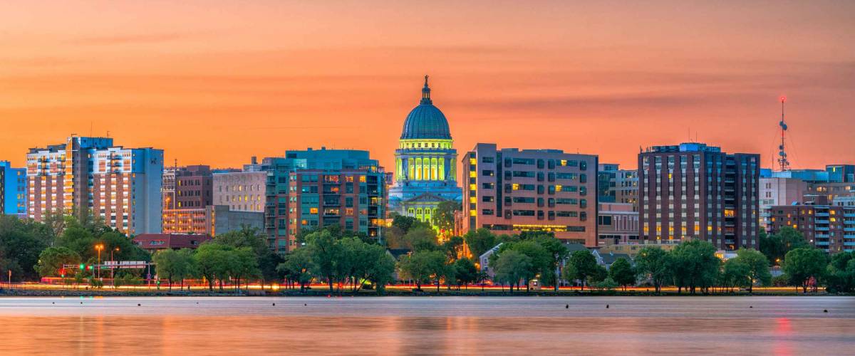 Madison, Wisconsin, USA downtown skyline at dusk on Lake Monona.